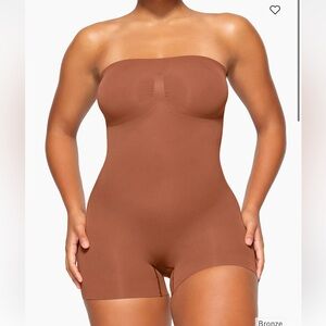 SKIMS Strapless Sculpting Bodysuit in Bronze